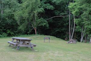 a picnic table and a sign in a park at Lubānas mototrase in Lubāna
