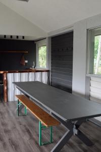 a ping pong table in a room with a bench at Lubānas mototrase in Lubāna