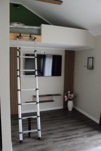 a bunk bed in a room with a ladder at Lubānas mototrase in Lubāna +4 photos