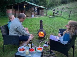a group of people sitting around a fire at Unique Dutch Retro House "Stará Láska" - Natural Slovakia in Modrý Kameň