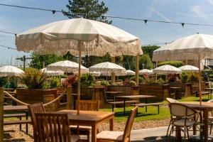 a group of tables and chairs with umbrellas at The Mayflower in Lymington