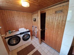 a laundry room with a washing machine in a room at Ferienwohung Lederle in Weiler-Simmerberg