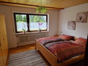 a bedroom with a bed and a window at Ferienwohung Lederle in Weiler-Simmerberg