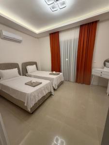 a hotel room with two beds and a window at Villa Lost dalaman in Çakallık +7 photos