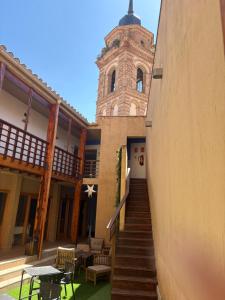 a building with a clock tower and a staircase at Castillo Fortaleza de Ateca in Ateca