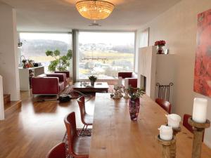 a living room with a table and chairs and a large window at Boutique Villa Maria Plain in Radeck