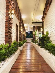 a hallway of a building with plants at Alona Marga in Panglao Island