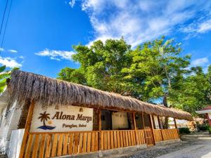 a building with a thatamboo roof on top of it at Alona Marga in Panglao Island