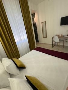 a bedroom with a large white bed with yellow pillows at Trapani Urban Nest in Trapani +34 photos