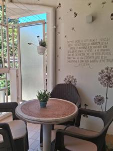 a room with a table and chairs and a window at STRUNA in Ohrid +12 photos
