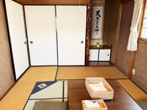an empty room with a table and a chair at おかげ参り宿場 in Ise +48 photos
