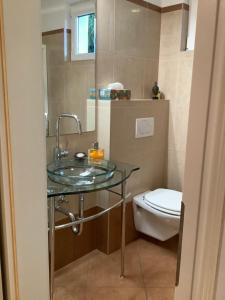 a bathroom with a sink and a toilet at Boutique Villa Maria Plain in Radeck +18 photos