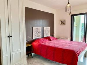 a bedroom with a red bed with a red blanket at Luxurious apartment seafront Moraira by Moraira Holiday Homes in Moraira