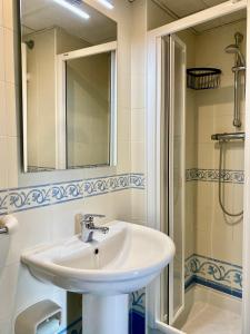 a bathroom with a sink and a shower and a mirror at Luxurious apartment seafront Moraira by Moraira Holiday Homes in Moraira +11 photos