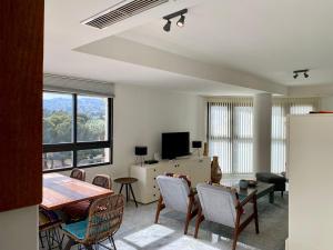 a living room with a table and chairs at Luxurious apartment seafront Moraira by Moraira Holiday Homes in Moraira