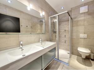 a bathroom with a sink and a shower and a toilet at Peak View Penthouse Kaprun in Kaprun +36 photos