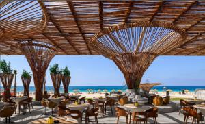 a restaurant with tables and chairs on the beach at LYV Boutique Cabana in Marsa Matruh +6 photos