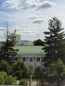 a building with a gold dome on top of it at Apelsin apartment in Bila Tserkva