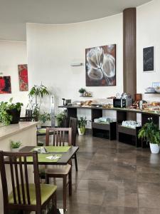 a restaurant with a table and chairs and a counter at Life Sport Hotel in Mentana