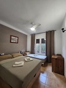 a bedroom with two beds and a window at 2 Duplex Las Terrazas Cubes in Vélez de Benaudalla +32 photos