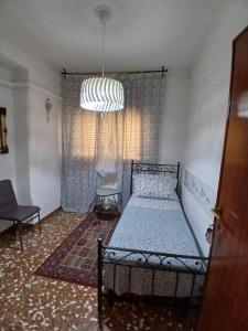 a bedroom with a bed and a large window at Casa Giulia In in Pisa