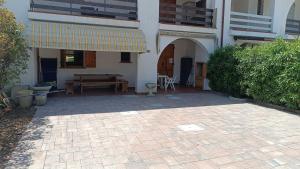 a patio of a house with a table and awning at Pomposa 41 in Lido di Pomposa