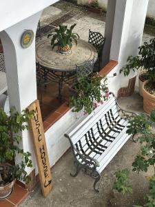 a white bench sitting on a porch with a table at Music House Palinuro in Palinuro
