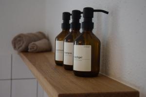 three bottles of wine sitting on a wooden shelf at TheCozyHideaway in Lungern