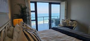 a bedroom with a bed and a view of the ocean at Benka Beach, Sheffield, KwaZulu Natal in Sheffield Beach +123 photos