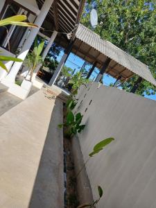 a concrete wall with plants next to a house at Kentz villa in Arugam Bay