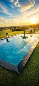 a large swimming pool with blue water and a hoop at Horizon Crown Rooms Ulcinj in Briska Gora
