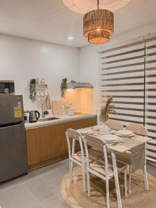 a dining room with a table and a kitchen at South Haven in Calo