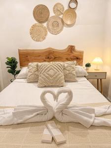 a bed with two heart shaped towels on it at South Haven in Calo +20 photos