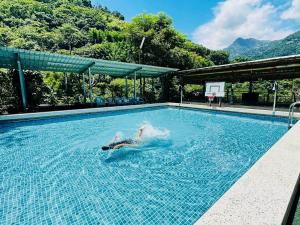 a person is swimming in a swimming pool at 東光行旅 in Xinyi