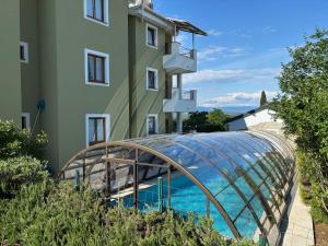 a building with a glass dome next to a building at Apartments Salatić in Krk