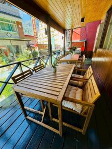 a wooden table and chairs on a balcony at 東光行旅 in Xinyi
