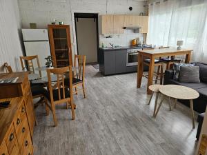 a kitchen and living room with a table and chairs at Leilighet 6 in Dalen