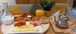 a table with a plate of breakfast foods and drinks at Suite Loc Suite & Spa in Casablanca +132 photos