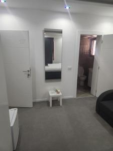 a living room with a bed and a mirror at Prenociste T-07 in Smederevo +95 photos