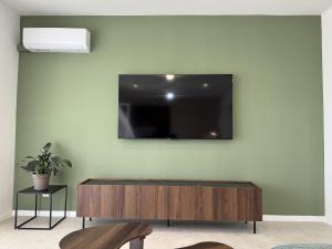 a living room with a tv on a wall at Apartment Terra Verde in Kastel Stari +44 photos