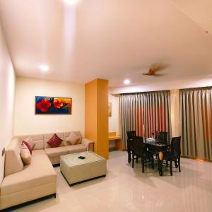 a living room with a couch and a table at Hotel Siddharth Grand in Varanasi