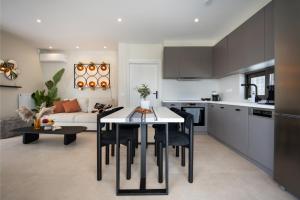 a kitchen and living room with a table and chairs at Kaerati Athens in Vari