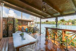 a house on the water with a table and chairs at Bamboo River House in Ulcinj