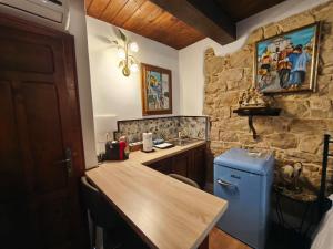 a kitchen with a wooden counter and a blue refrigerator at La Casa delle Rondini in Baunei