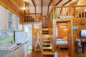 a tiny house with a staircase in a kitchen at Bamboo River House in Ulcinj