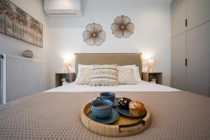a tray with breakfast foods on a bed at Kaerati Athens in Vari +38 photos