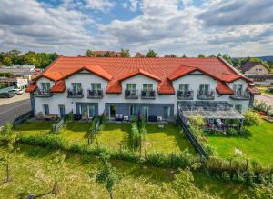 an aerial view of a house with an orange roof at Apartamenty Prusa in Mikołajki