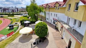 a balcony of a building with a table and benches at Hotelik MOSiR Reda in Reda