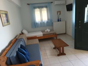 a room with a couch and a bed and a table at Panorama Apartment 1 in Moúdhros +1 photo