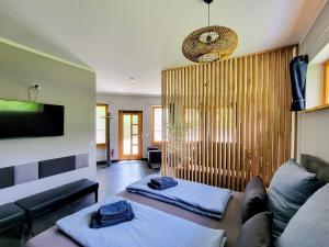 a living room with two beds and a couch at Heideberg Appartement in Zeuthen